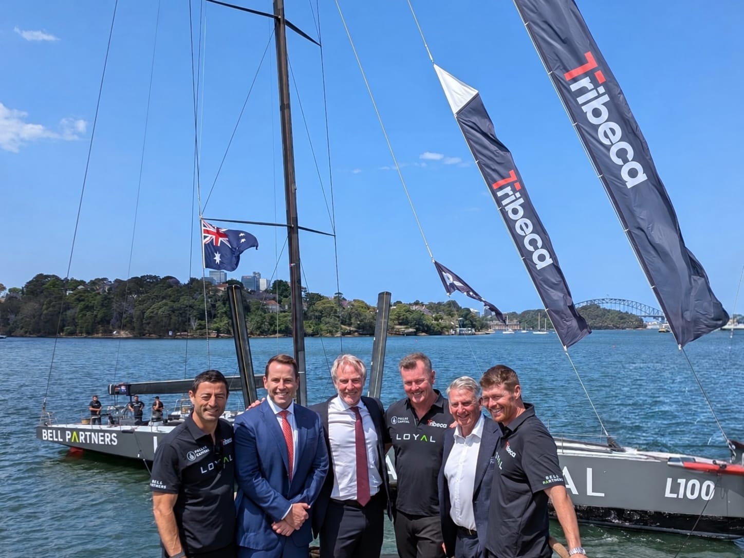 Tribeca and LOYAL team members on the dock beside the LOYAL yacht